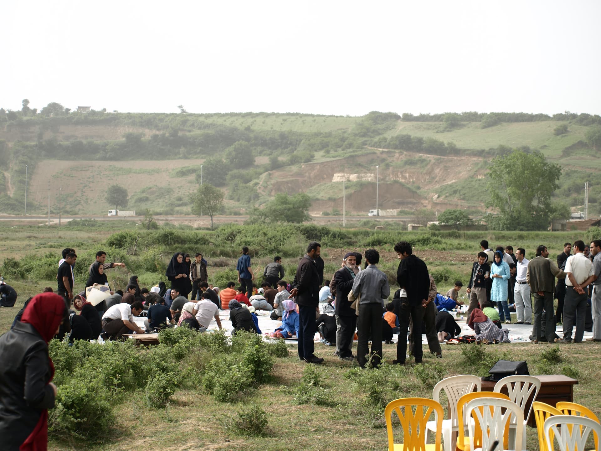 Open-air community gathering around finished artworks at Art in Village festival, Iran